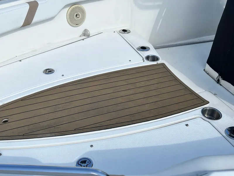 Slide: The Image of 2014 Striper 220 Center Console boat deck with cup holders and speaker. - 44