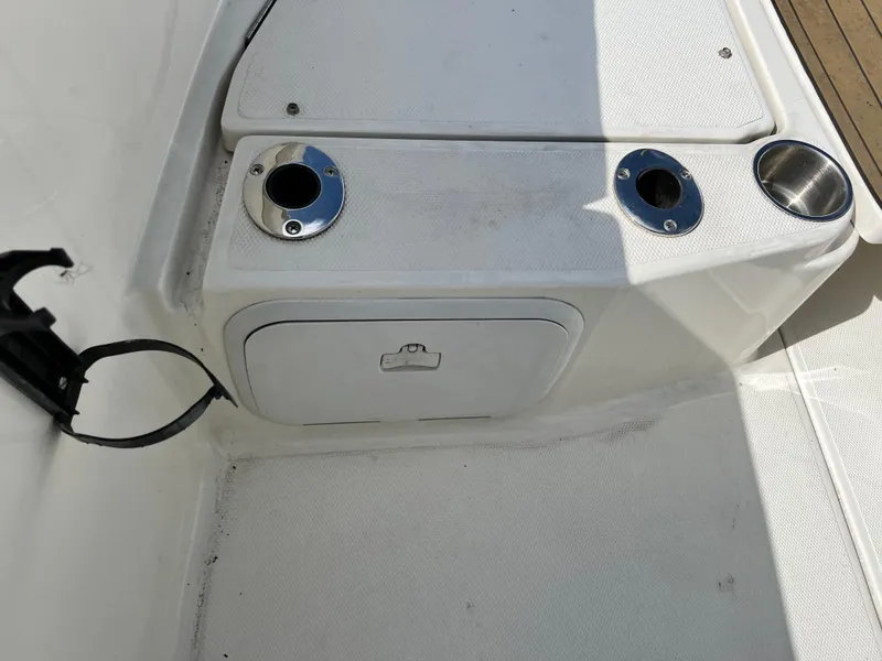 Slide: The Image of 2014 Striper 220 Center Console boat interior with cup holders and storage compartment. - 46