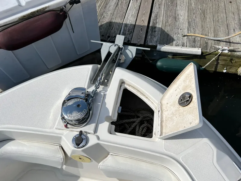 Slide: The Image of 2014 Striper 220 Center Console boat with anchor storage and winch at dock. - 48
