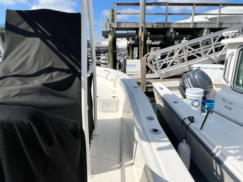 Slide: The Image of 2014 Striper 220 Center Console boat docked beside another vessel. - 6