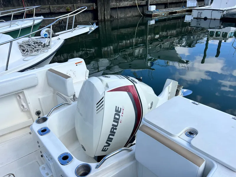 Slide: The Image of 2014 Striper 220 Center Console with Evinrude engine docked in marina. - 7