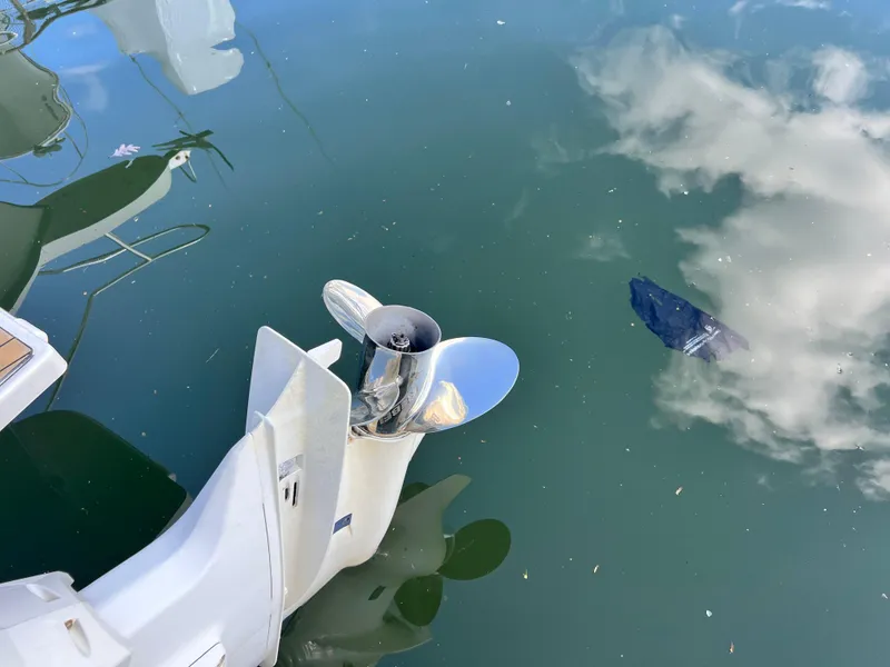 Slide: The Image of Outboard motor propeller of 2014 Striper 220 Center Console in reflective water. - 9