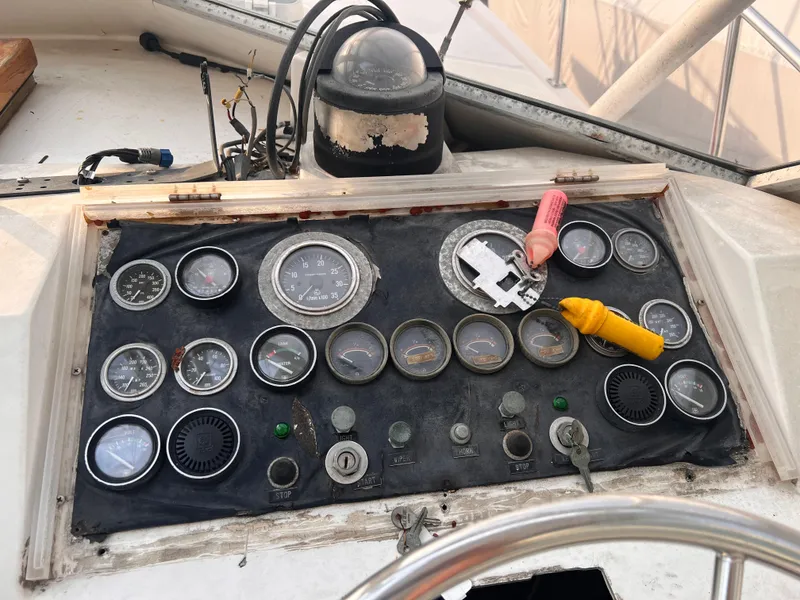 Slide: The Image of Control panel of a 1988 Canyon Bay 40 boat with gauges and switches. - 14