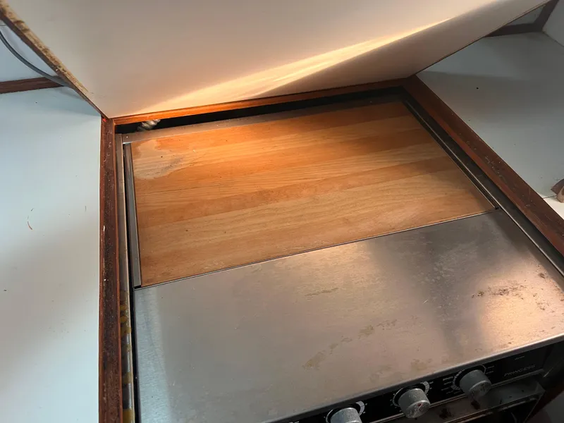 Slide: The Image of Built-in stove with wooden cover on a 1988 Canyon Bay 40 boat. - 22