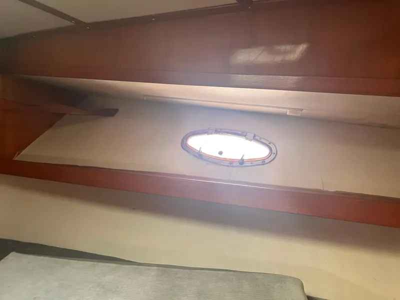 Slide: The Image of Interior cabin of 1988 Canyon Bay 40 boat with wooden trim and porthole window. - 29