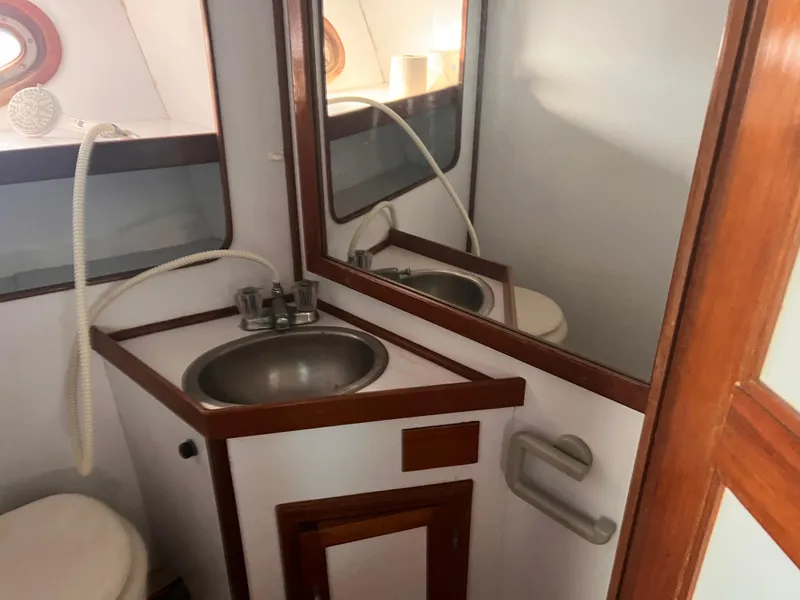 Slide: The Image of Bathroom interior of 1988 Canyon Bay 40 boat with sink and mirror. - 33