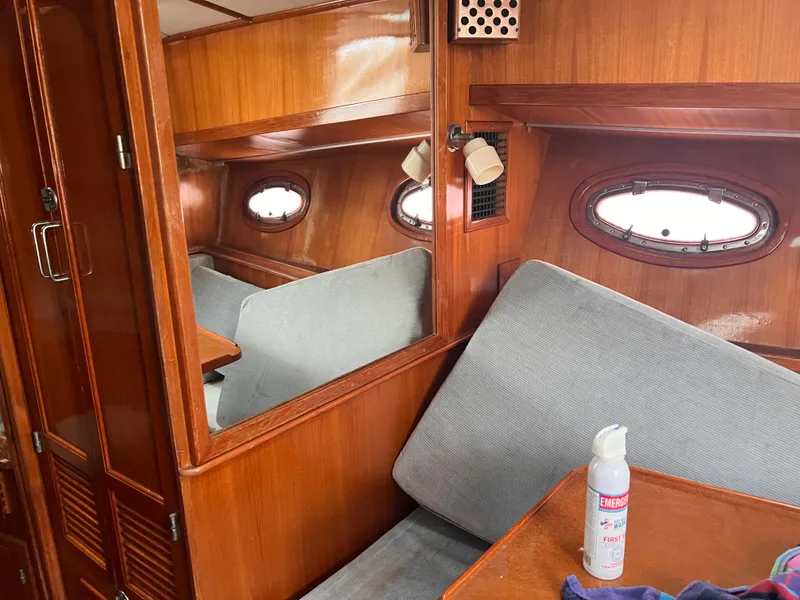 Slide: The Image of Interior of 1988 Canyon Bay 40 boat with wooden paneling and seating area. - 34