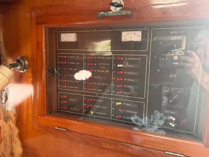 Slide: The Image of Electrical control panel on a 1988 Canyon Bay 40 boat, featuring various switches and meters. - 35