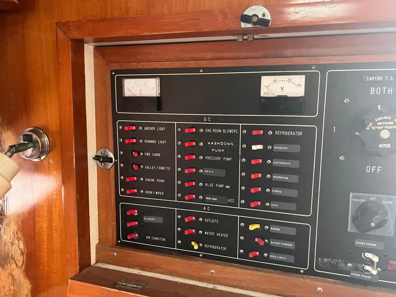 Slide: The Image of Control panel of a 1988 Canyon Bay 40 boat with switches and gauges. - 36
