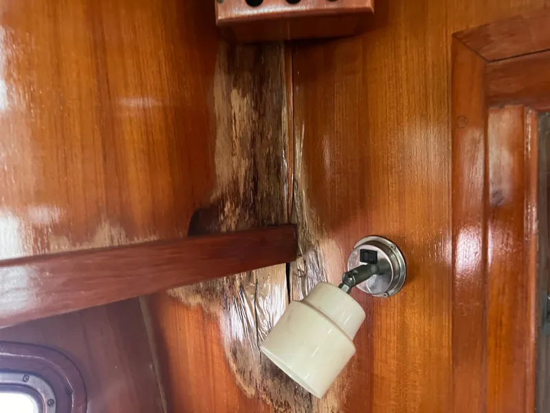Slide: The Image of Wooden interior of 1988 Canyon Bay 40 boat with light fixture and water damage. - 39