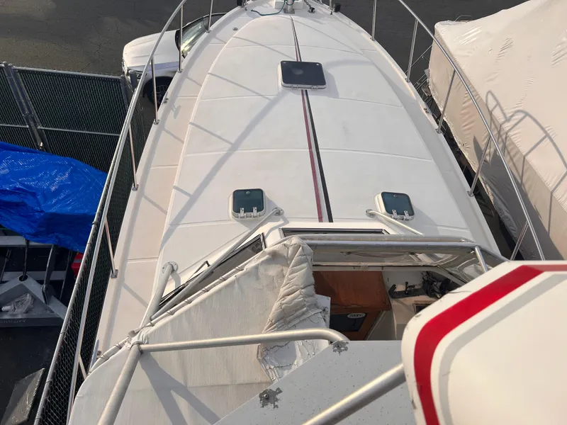 Slide: The Image of 1988 Canyon Bay 40 boat deck, aerial view, docked with protective covers. - 46