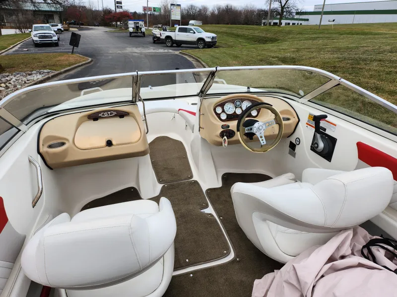 Slide: The Image of 2008 Glastron GT 205 boat interior with white seats and dashboard. - 11
