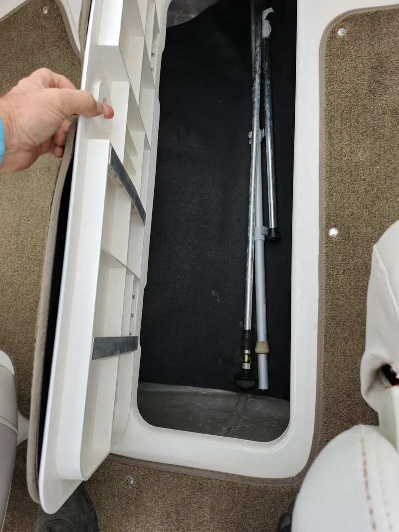 Slide: The Image of Storage compartment in a 2008 Glastron GT 205 boat with equipment inside. - 15