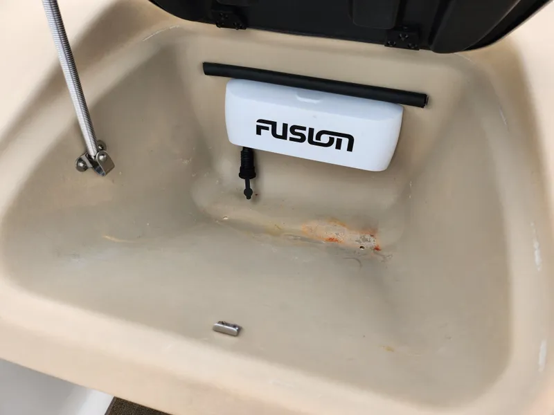 Slide: The Image of Storage compartment of a 2008 Glastron GT 205 boat with Fusion audio equipment. - 16
