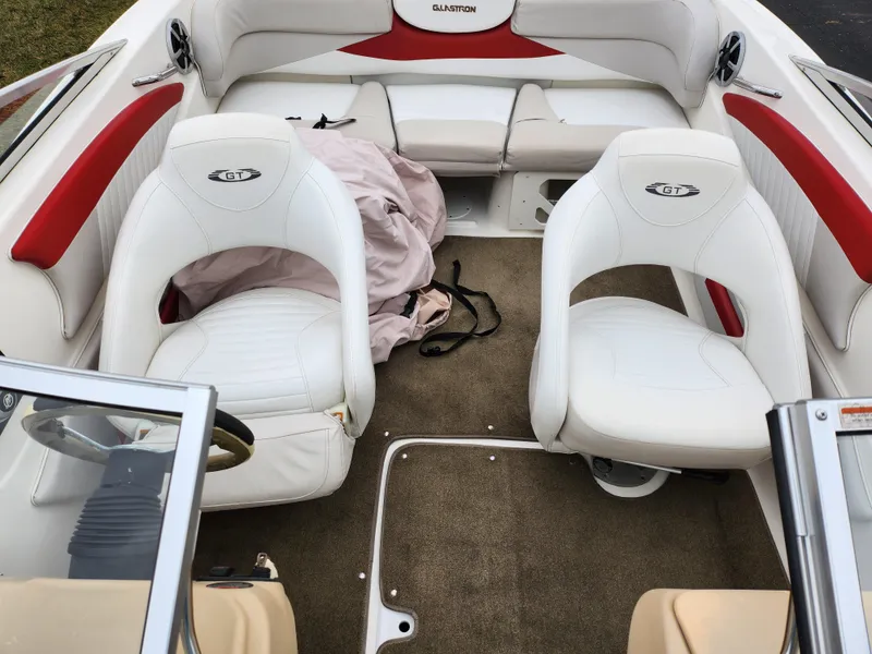 Slide: The Image of 2008 Glastron GT 205 boat interior with white and red seating. - 21