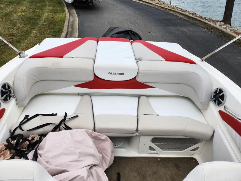 Slide: The Image of 2008 Glastron GT 205 boat interior with red and white seating. - 22