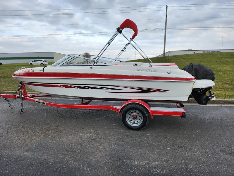 Slide: The Image of 2008 Glastron GT 205 boat with red accents on a matching trailer. - 4