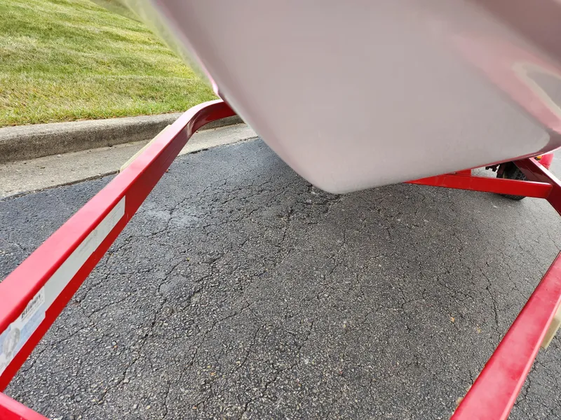 Slide: The Image of 2008 Glastron GT 205 boat on red trailer, close-up view. - 7