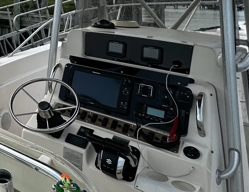 Slide: The Image of 1996 Grady-White Chase 263 boat dashboard with steering wheel and navigation equipment. - 3