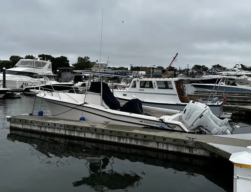 Slide: The Image of 1996 Grady-White Chase 263 boat docked in a marina, overcast sky. - 5