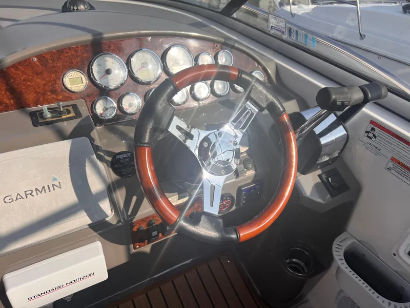 Slide: The Image of 2011 Regal 35 Express Cruiser dashboard with Garmin navigation and wood-accented steering wheel. - 15