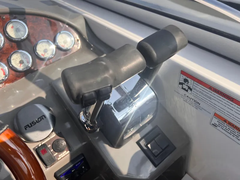 Slide: The Image of Control panel of 2011 Regal 35 Express Cruiser with throttle and gauges. - 18