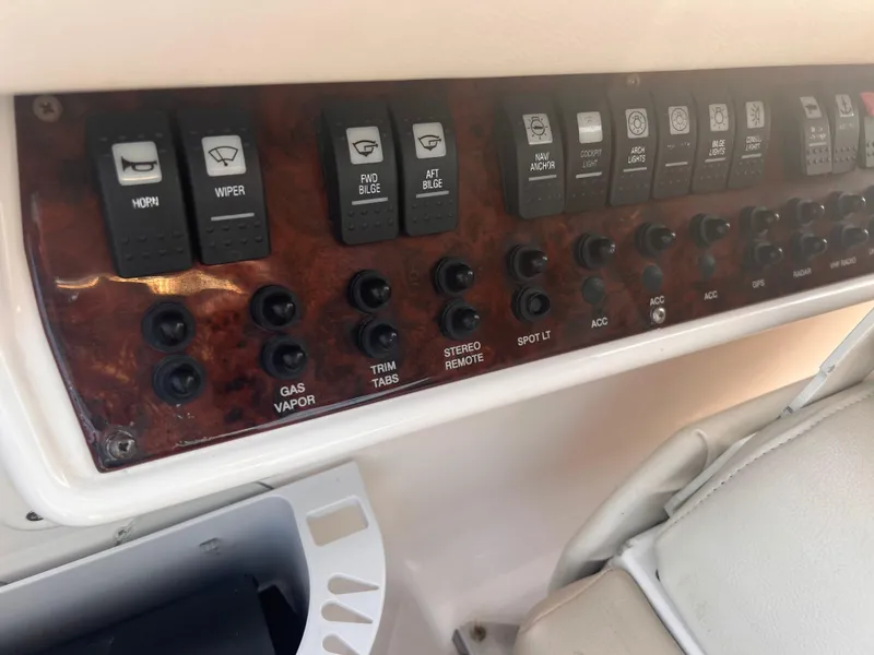 Slide: The Image of Control panel of a 2011 Regal 35 Express Cruiser with various switches and buttons. - 20