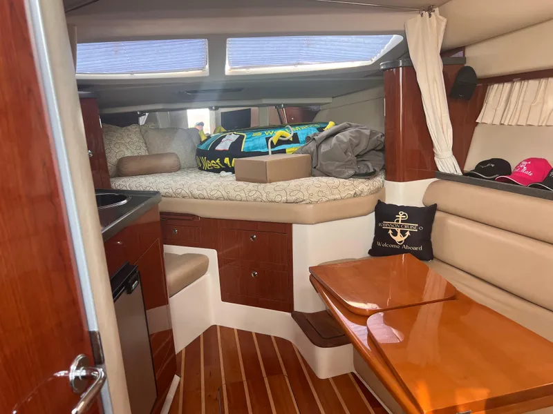 Slide: The Image of Interior of 2011 Regal 35 Express Cruiser with cozy seating and wooden finishes. - 23