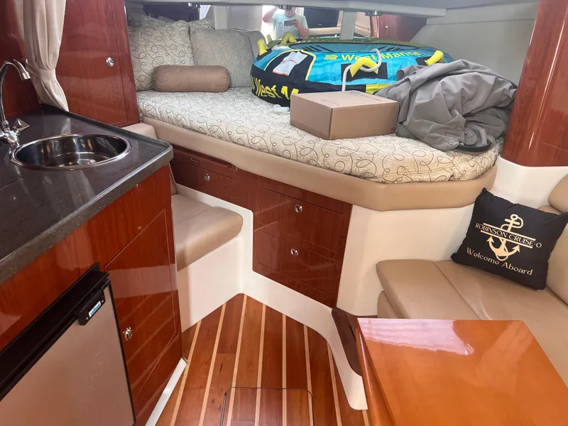 Slide: The Image of Interior of 2011 Regal 35 Express Cruiser with cozy seating and kitchenette. - 24