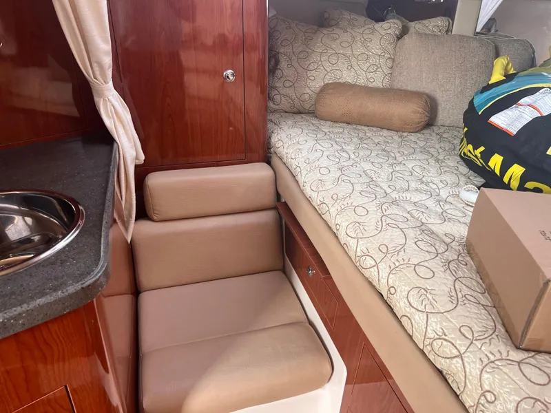 Slide: The Image of Interior of 2011 Regal 35 Express Cruiser with bed, seating, and sink. - 25