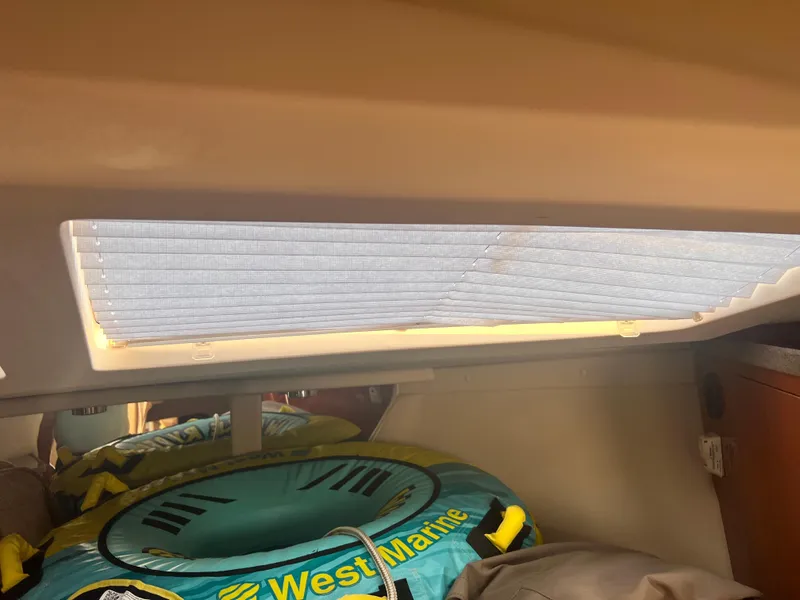 Slide: The Image of Interior of 2011 Regal 35 Express Cruiser with window shade and inflatable water tube. - 26