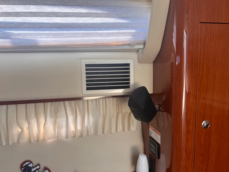 Slide: The Image of Interior of 2011 Regal 35 Express Cruiser with wood paneling and air vent. - 29