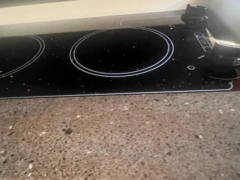 Slide: The Image of Stovetop on 2011 Regal 35 Express Cruiser with speckled countertop. - 32