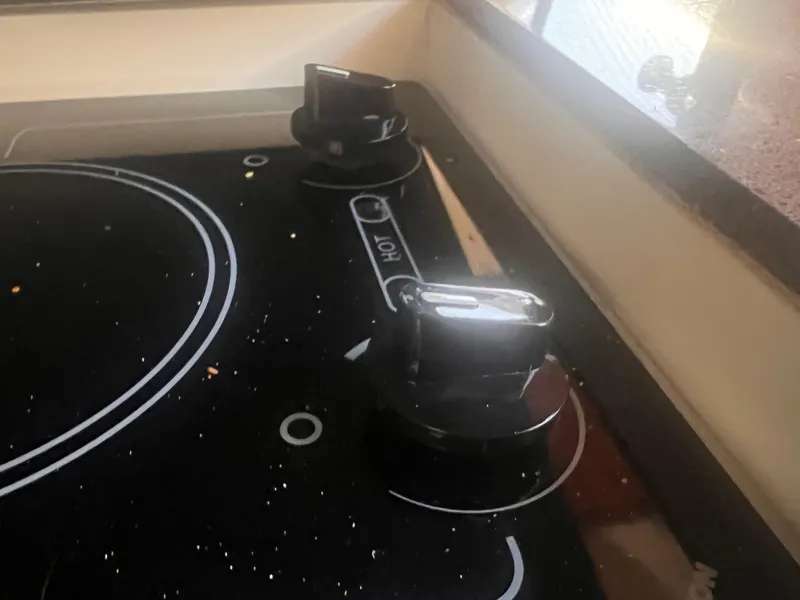 Slide: The Image of Stovetop knobs on a 2011 Regal 35 Express Cruiser yacht kitchen. - 33