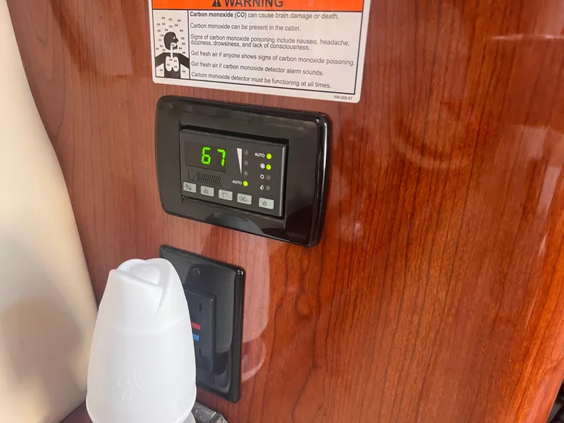 Slide: The Image of Thermostat display on 2011 Regal 35 Express Cruiser, showing 67 degrees, with carbon monoxide warning. - 41