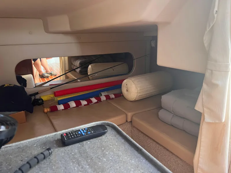 Slide: The Image of 2011 Regal 35 Express Cruiser interior with cushions, flags, and remote control. - 43