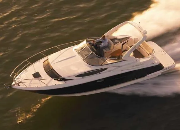 Slide: The Image of 2011 Regal 35 Express Cruiser speeding on water at sunset. - 44