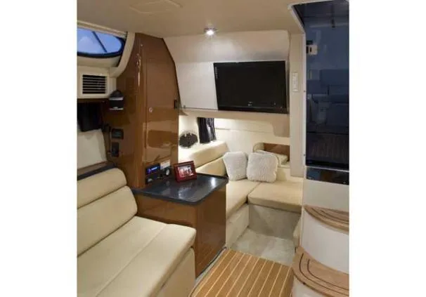 Slide: The Image of Interior of 2011 Regal 35 Express Cruiser with beige seating and modern amenities. - 47