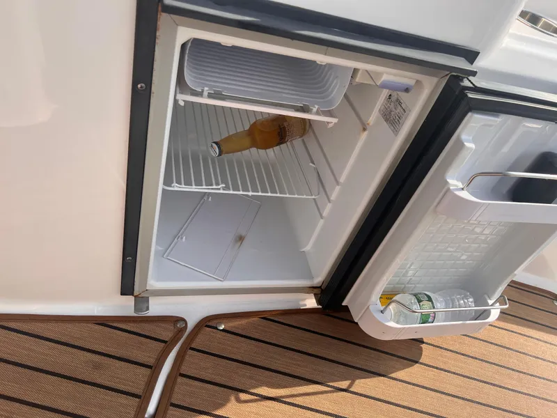 Slide: The Image of Open mini fridge on 2011 Regal 35 Express Cruiser with drinks inside. - 8