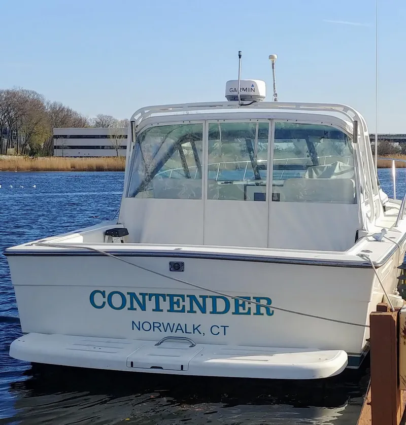 The Image of 1996 Pursuit 3100 Open boat docked, labeled "Contender" in Norwalk, CT. - 0