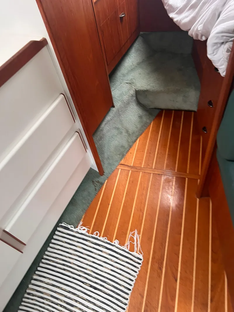 Slide: The Image of Interior of 1996 Pursuit 3100 Open boat with wood flooring and carpeted steps. - 14