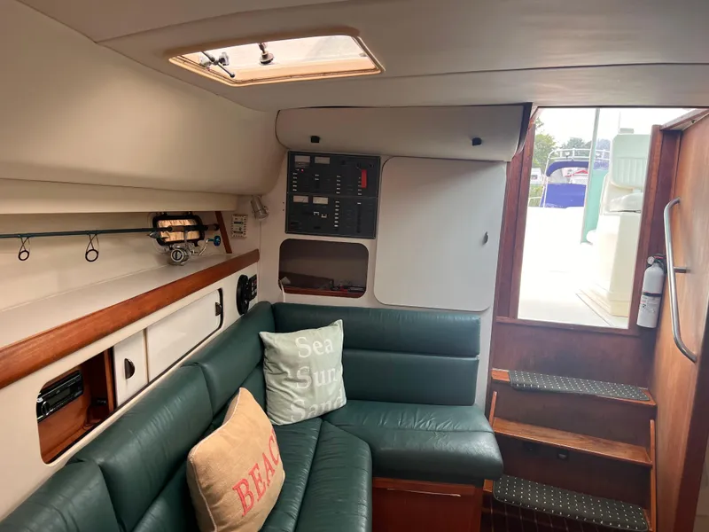 Slide: The Image of Interior of 1996 Pursuit 3100 Open boat with green seating and nautical decor. - 15