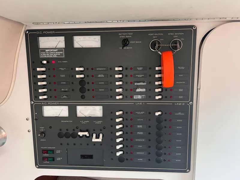 Slide: The Image of Electrical control panel of a 1996 Pursuit 3100 Open boat, featuring switches and gauges. - 19