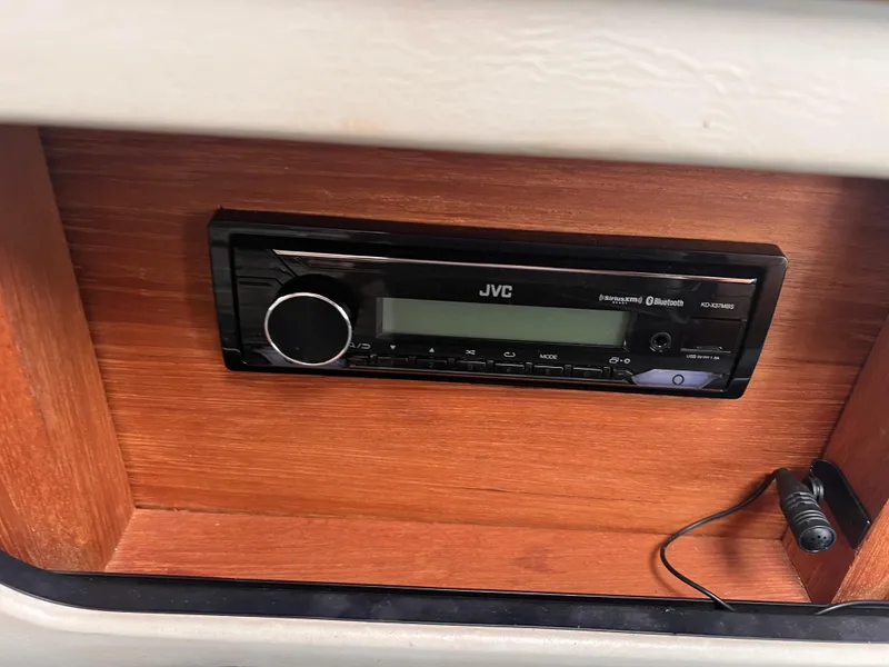 Slide: The Image of JVC stereo system in 1996 Pursuit 3100 Open boat, featuring Bluetooth and SiriusXM. - 20