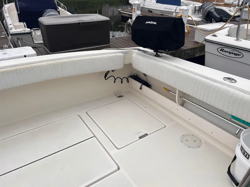 Slide: The Image of 1996 Pursuit 3100 Open boat deck with seating and storage compartments. - 24