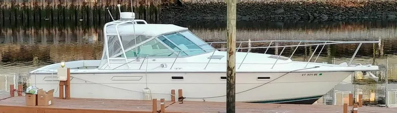 Slide: The Image of 1996 Pursuit 3100 Open boat docked by a calm waterfront. - 32