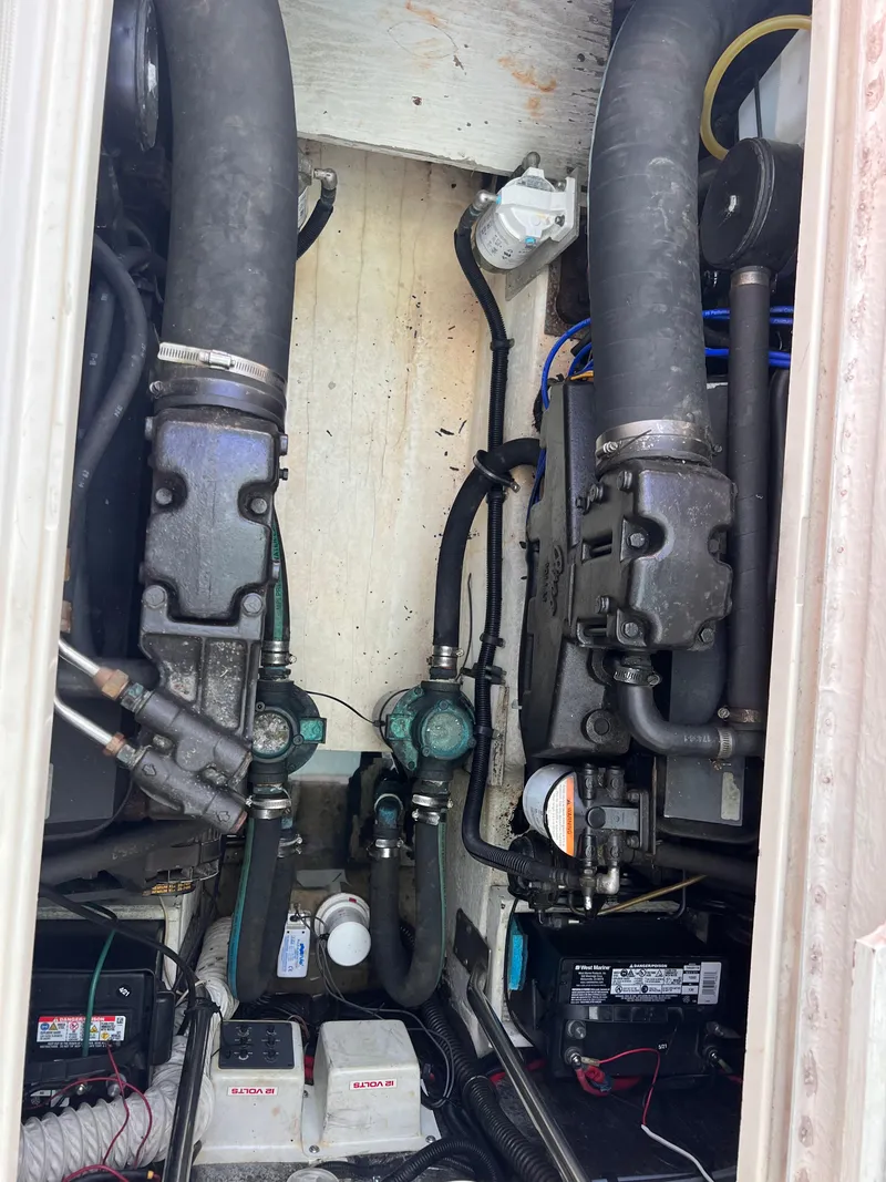 Slide: The Image of Engine compartment of a 1996 Pursuit 3100 Open boat, showing hoses and components. - 5