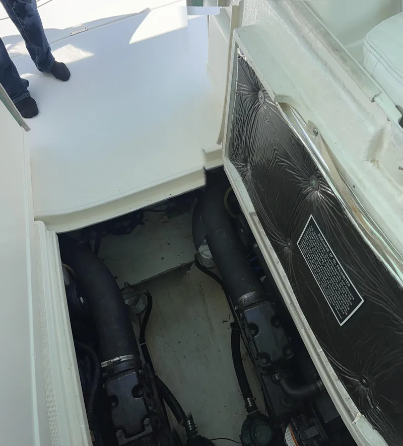 Slide: The Image of Engine compartment of a 1996 Pursuit 3100 Open boat, showing mechanical components. - 6