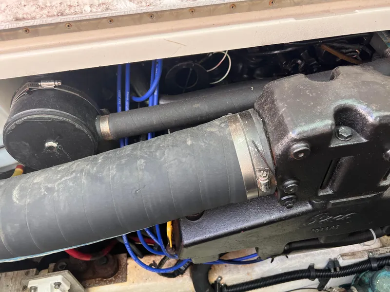 Slide: The Image of Engine compartment of a 1996 Pursuit 3100 Open boat, showing hoses and mechanical components. - 8