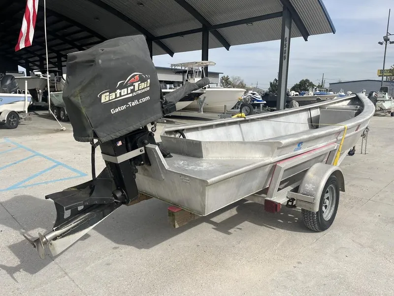 Slide: The Image of 2020 Custom 20 Crawfish Skiff with Gator Tail outboard motor on trailer. - 10